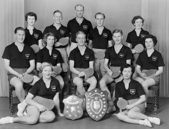 1954 Wellington Table Tennis Men’s and Women’s Teams.  Winners of the New Zealand Interprovincial Men’s and Women’s Teams Tournament. Left - Teague Shield (Women) and Kean Shield (Men). L/R: back: Pat Quinn, Ivan Houghton, John Crossley, Colin Shewan, Val Cousins Middle: John Sigley, Audrey Hughes, Tony Darroch, Murray Dunn, Eileen Brown Front: Thyra McGregor, Ann Wah